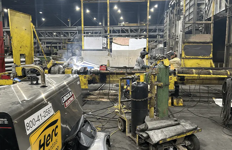 Industry workers welding machinery